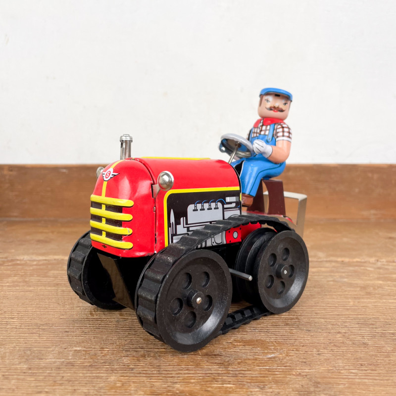 Red mechanical tractor and driver