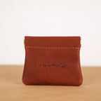 Tan leather kiss-lock coin purse