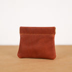 Tan leather kiss-lock coin purse