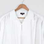 White Picasso shirt by Coline Diffusion on a hanger, gathered shoulders, one size