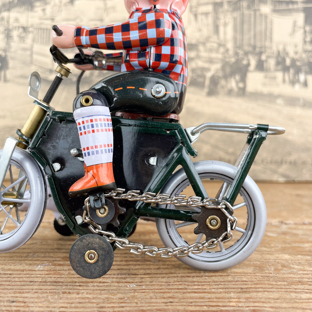 Garçon à bicyclette mécanique avec chien