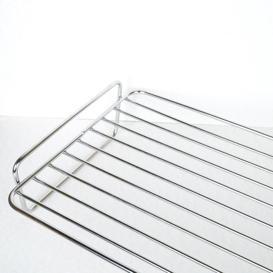 Kitchen Craft stainless steel roasting rack, close-up of wire bars and curved handle detail