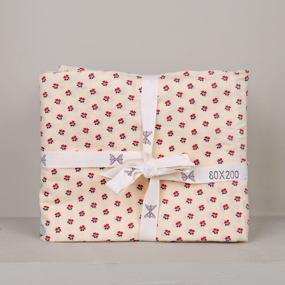 Pico red eiderdown cover 85x200 cm in block-printed cotton, hand-printed floral pattern, size 80x200 shown on the ribbon